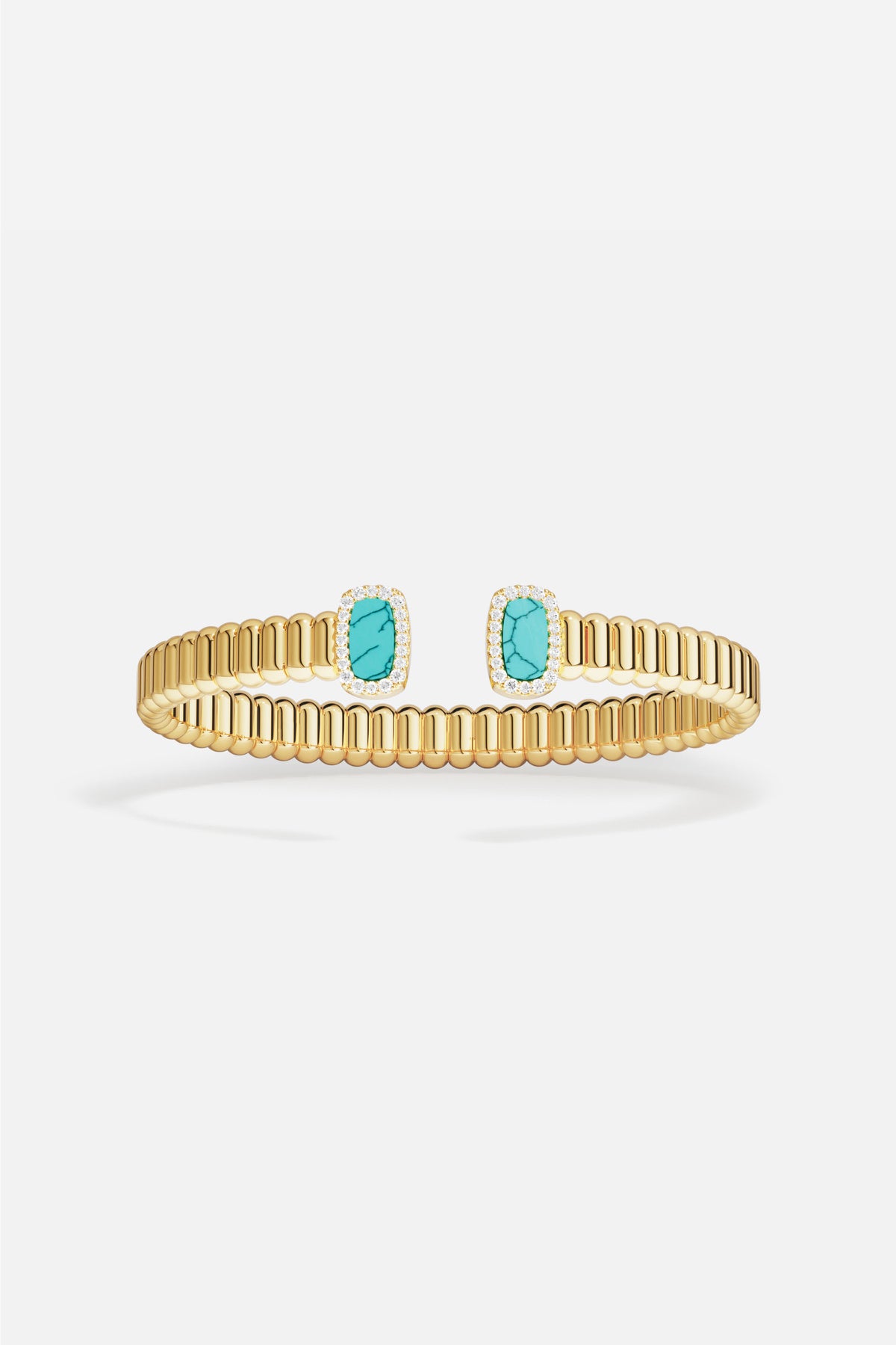 APM Monaco cuff bracelet in golden ribbed elegance, kissed by turquoise serenity.