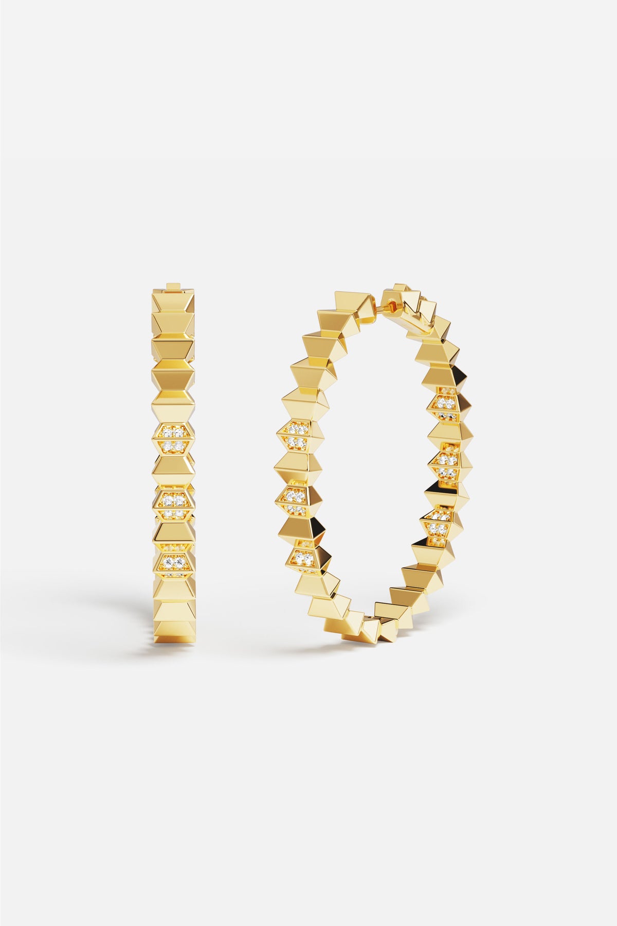 APM Hoop Earrings in gold color, bold edges meeting quiet sparkle.