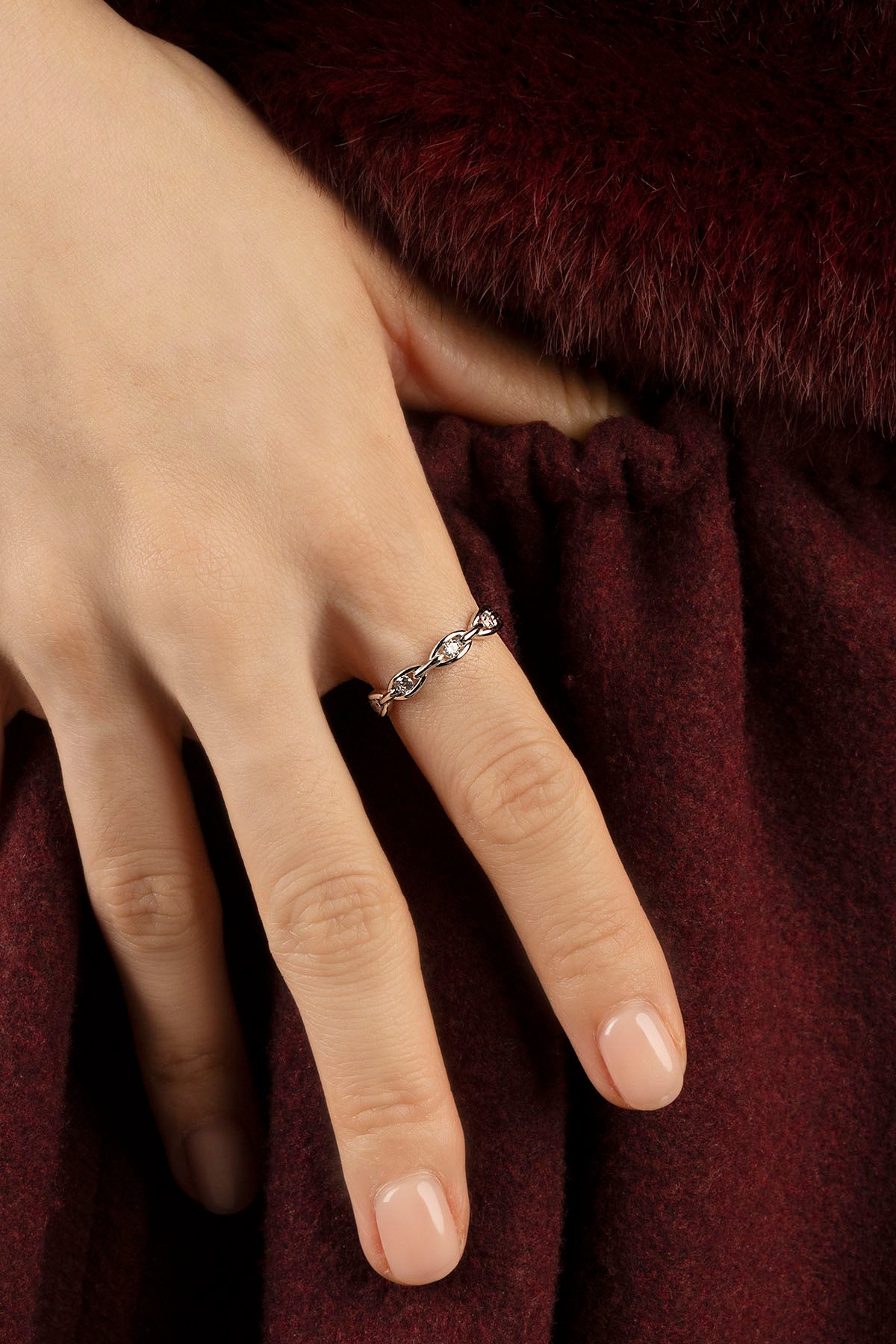 Woman wearing APM Morse Ring, a delicate rhodium finish whisper of modern elegance.