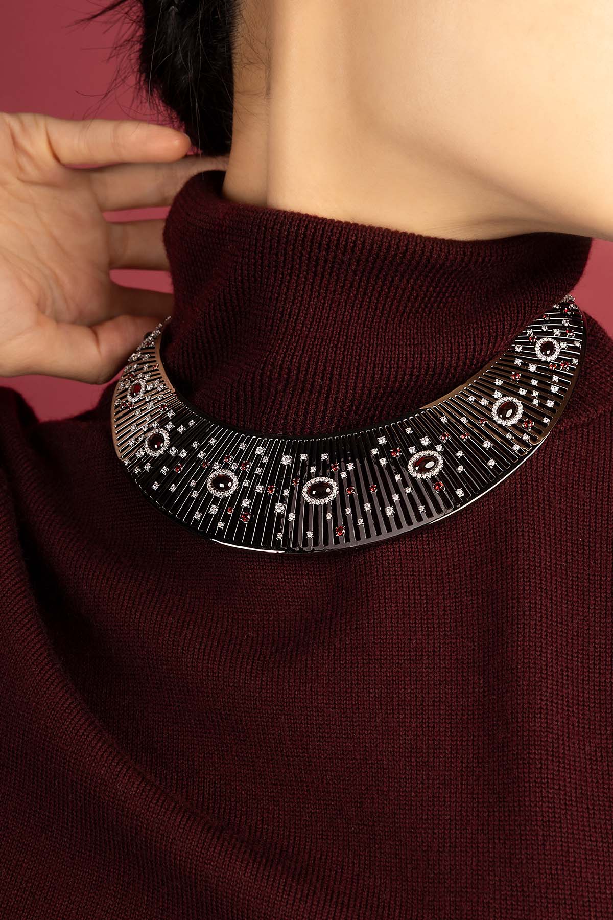Woman wearing APM Morse Necklace, a bold statement in rhodium finish.