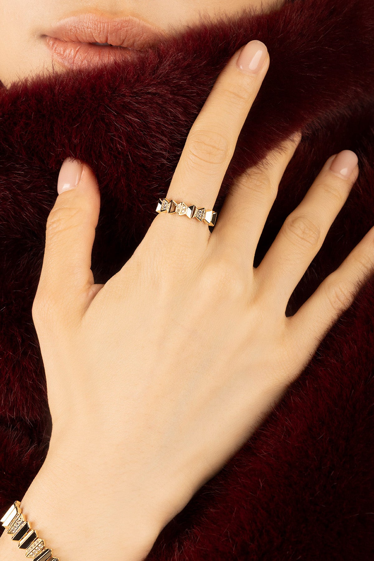 Woman wearing APM Morse Ring, a golden whisper of bold elegance.
