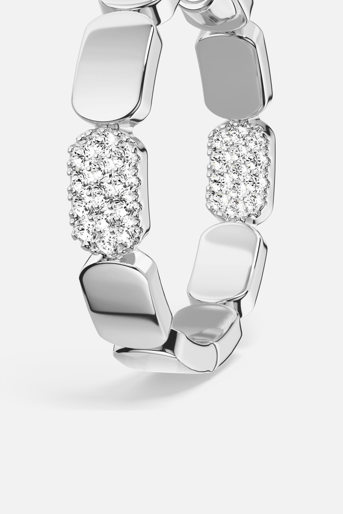 APM Ring in rhodium finish, sculptural links with a shimmering pavé glow.