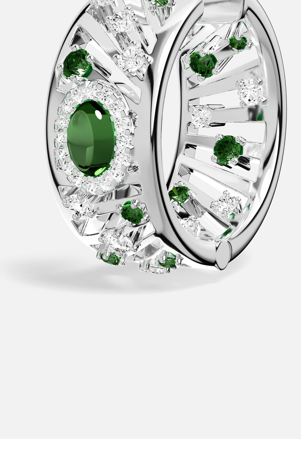APM Ring in rhodium finish, radiant green stones glowing with quiet confidence.
