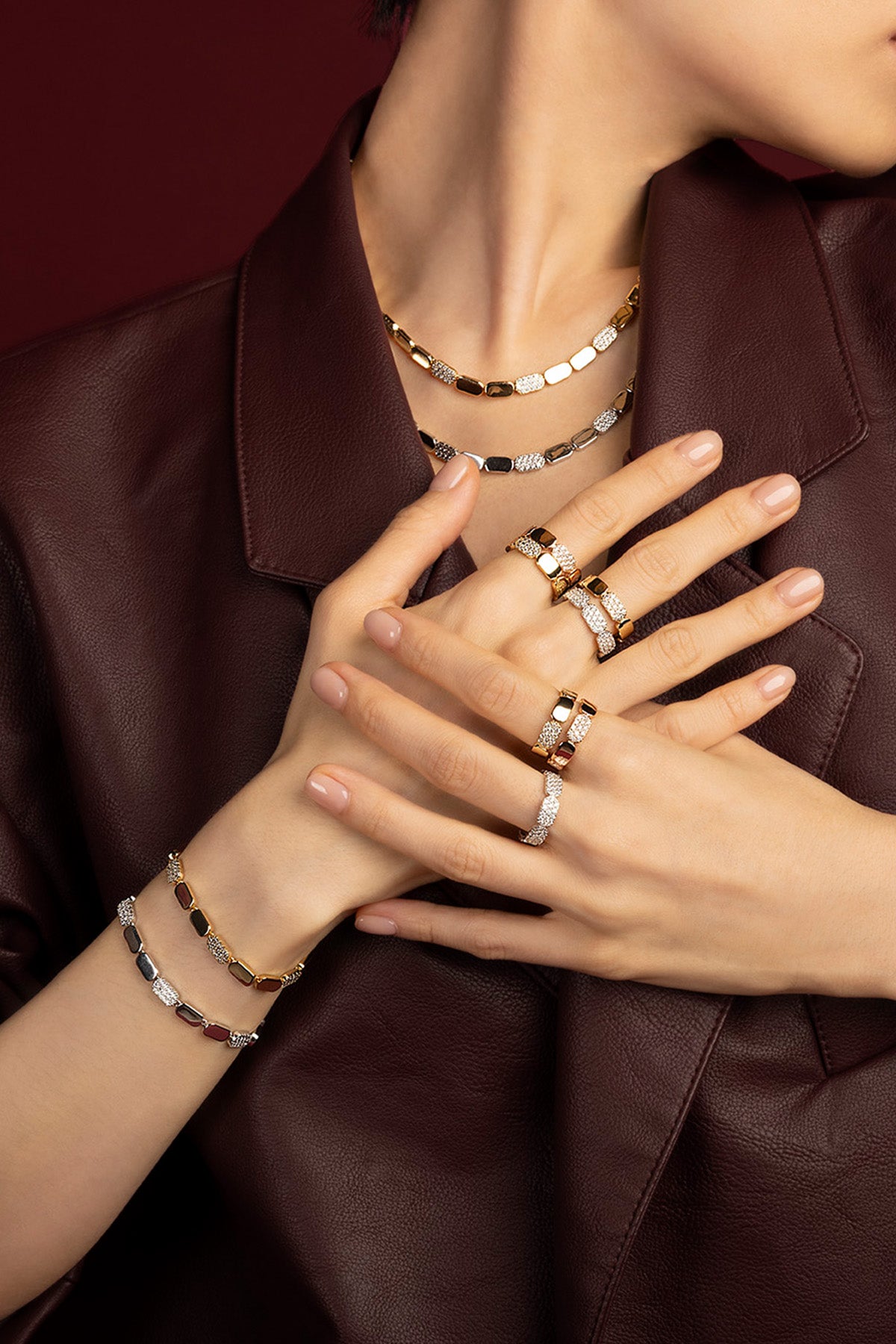 Woman wearing APM Monaco jewelry set, bold golden allure with a modern edge.