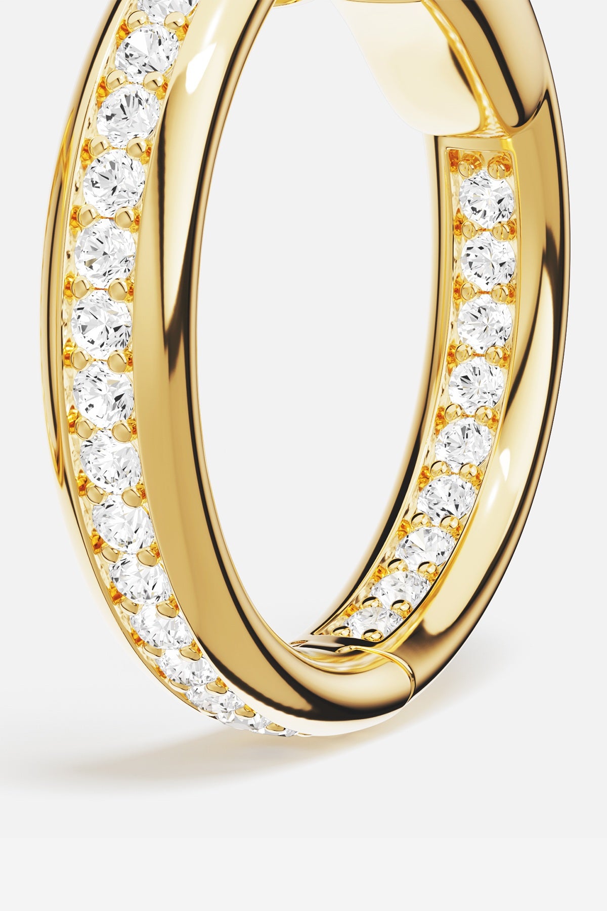 APM Monaco hoop earring in golden color, sparkling with quiet confidence and everyday radiance.