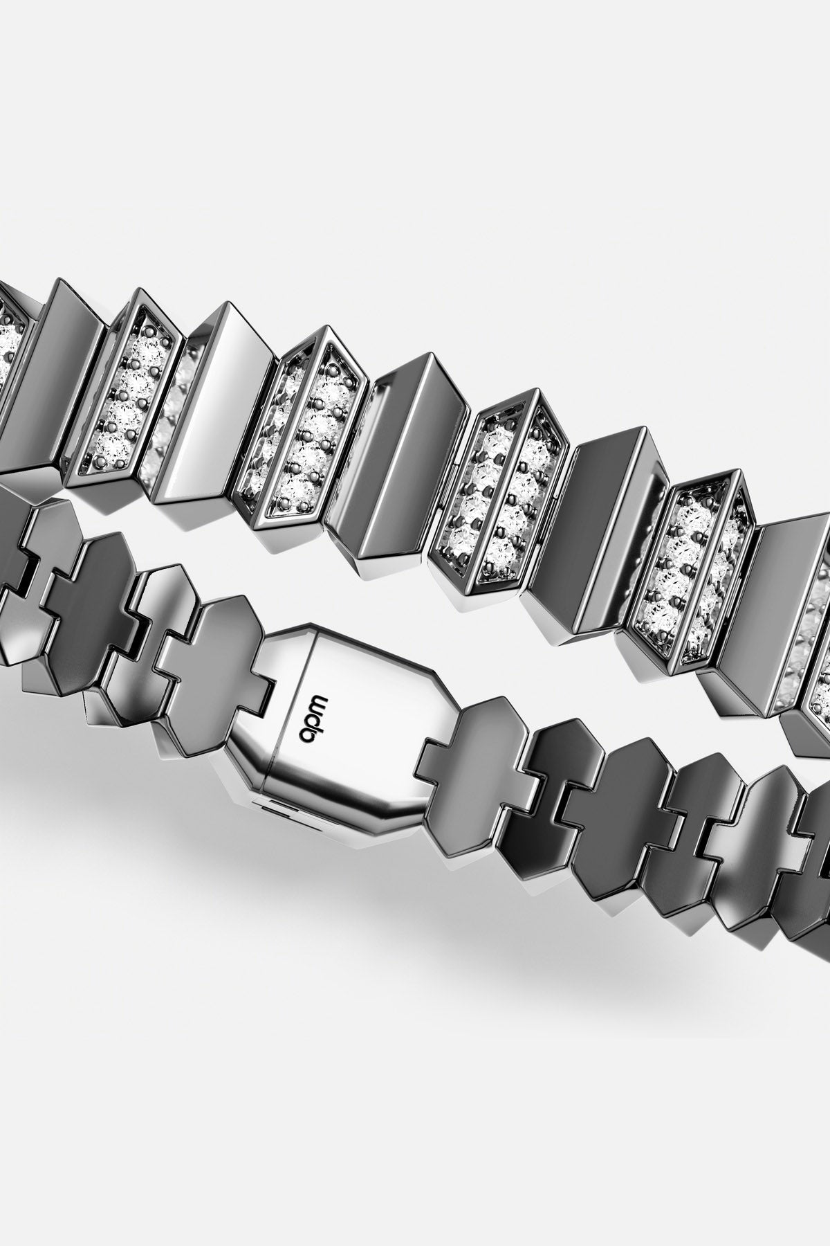 APM bracelet in rhodium finish, sharp architectural links glowing with modern edge.