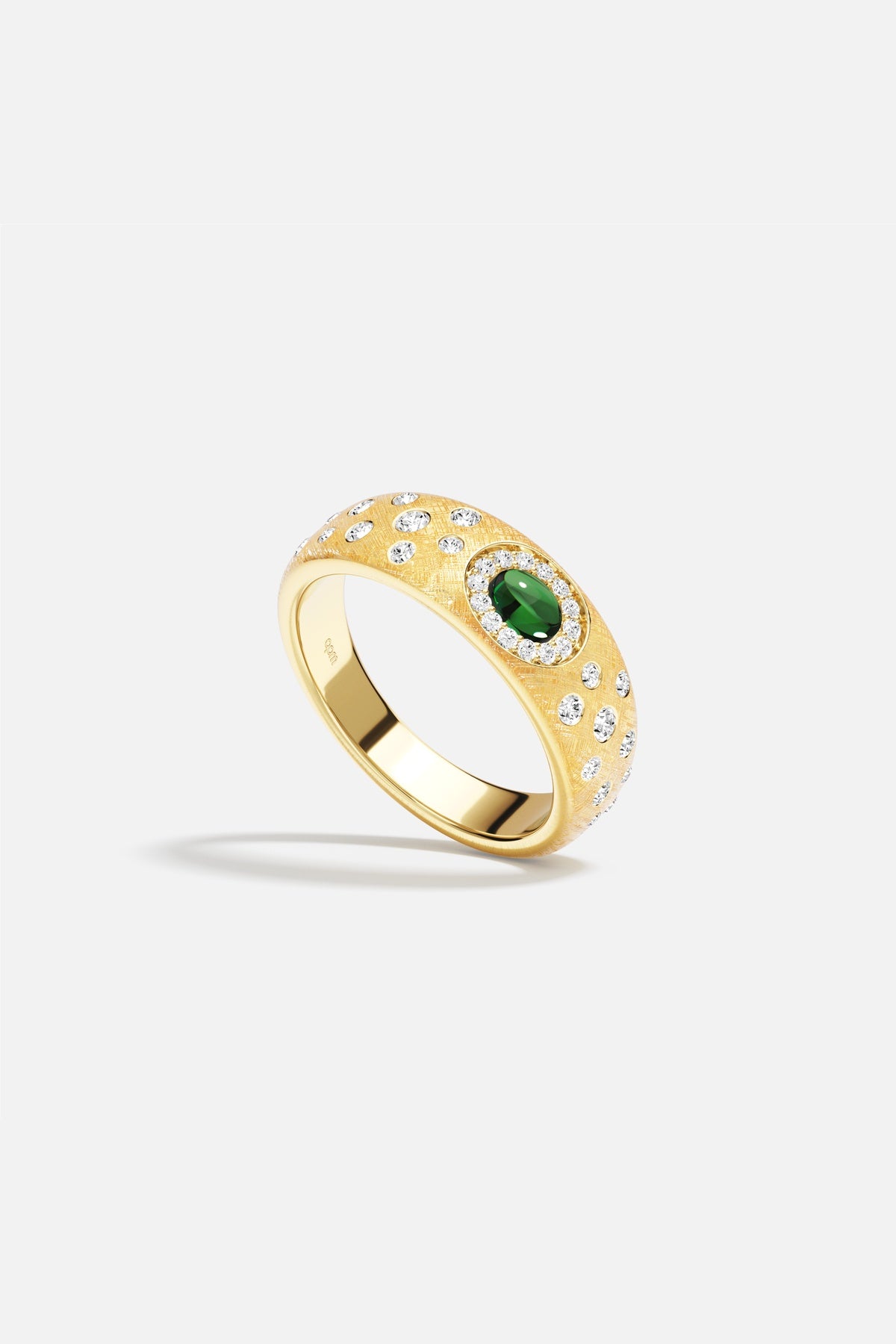 APM Ring in gold color, a green gem glowing with quiet radiance.