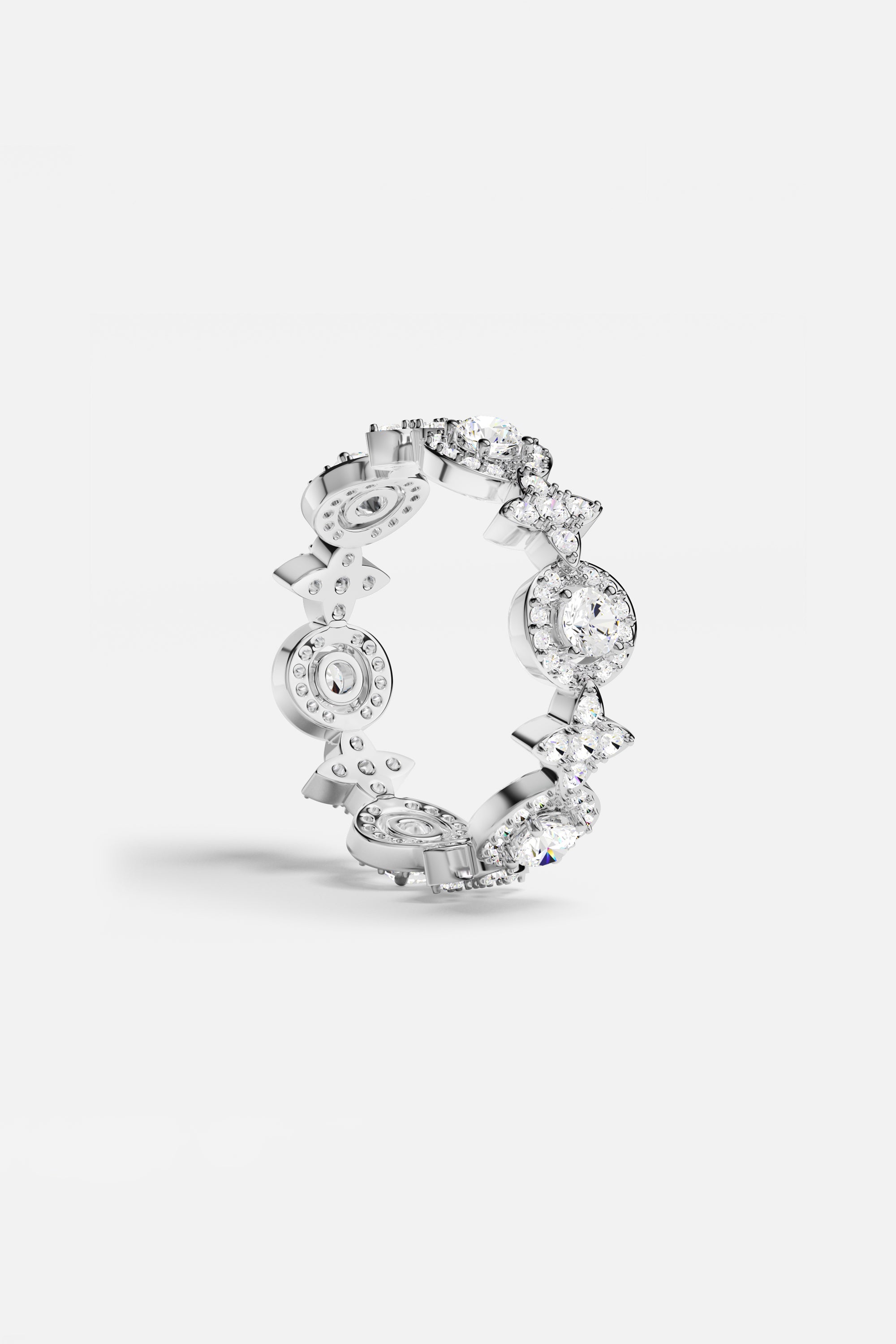 Rings APM Monaco: white pavé circle ring with multiple linked circular stone settings in a silver tone.