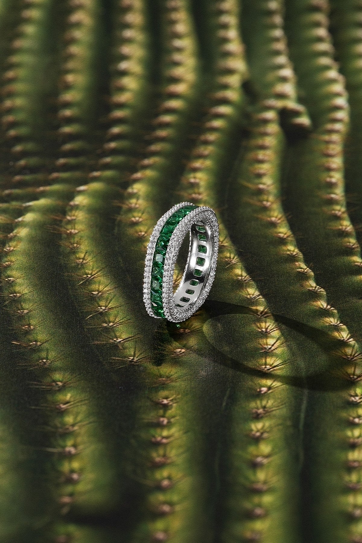 Ring with green stones on a cactus