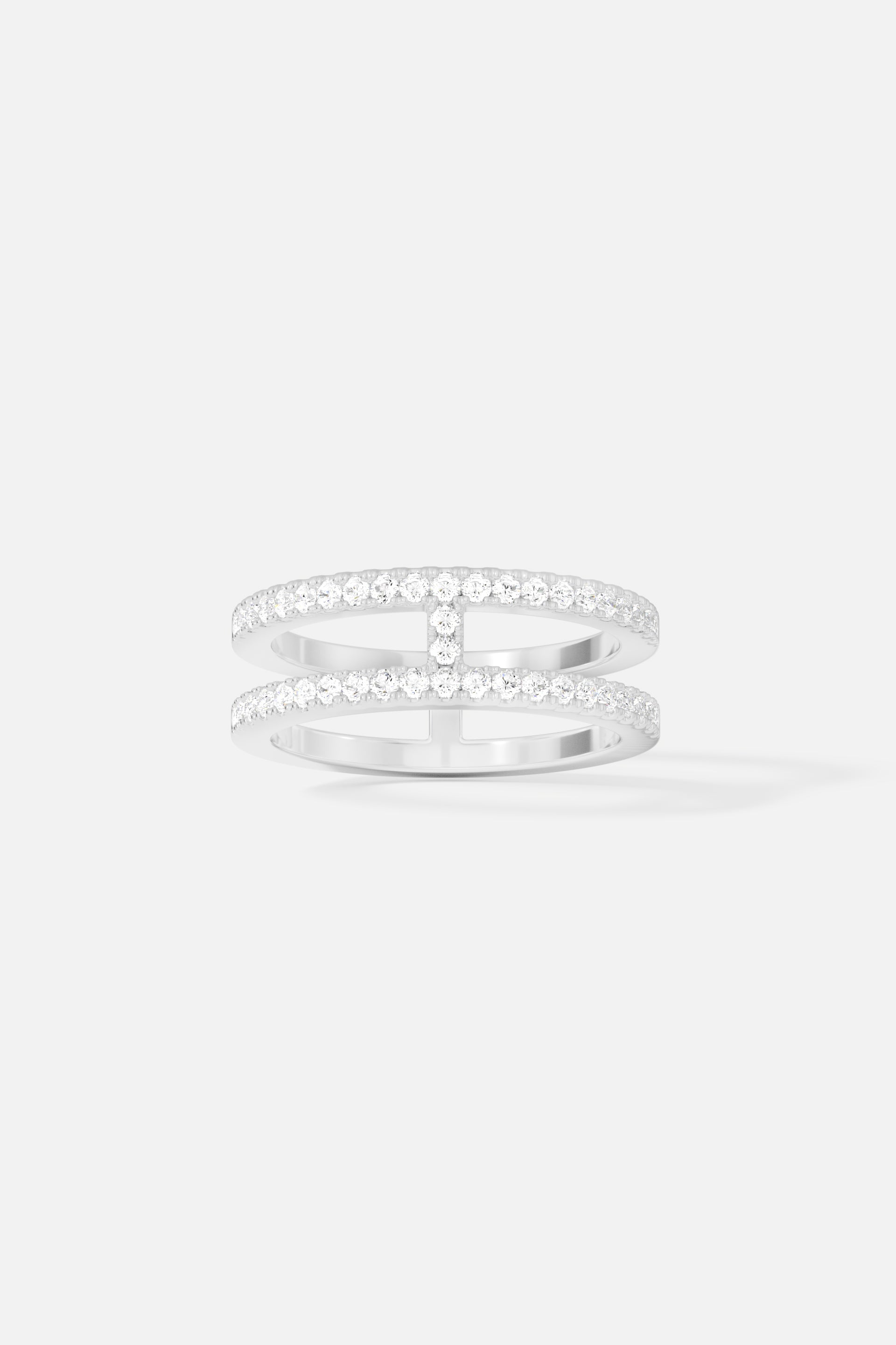 Rings APM Monaco: silver-toned ring with double pavé rows of small clear stones and two horizontal bars.