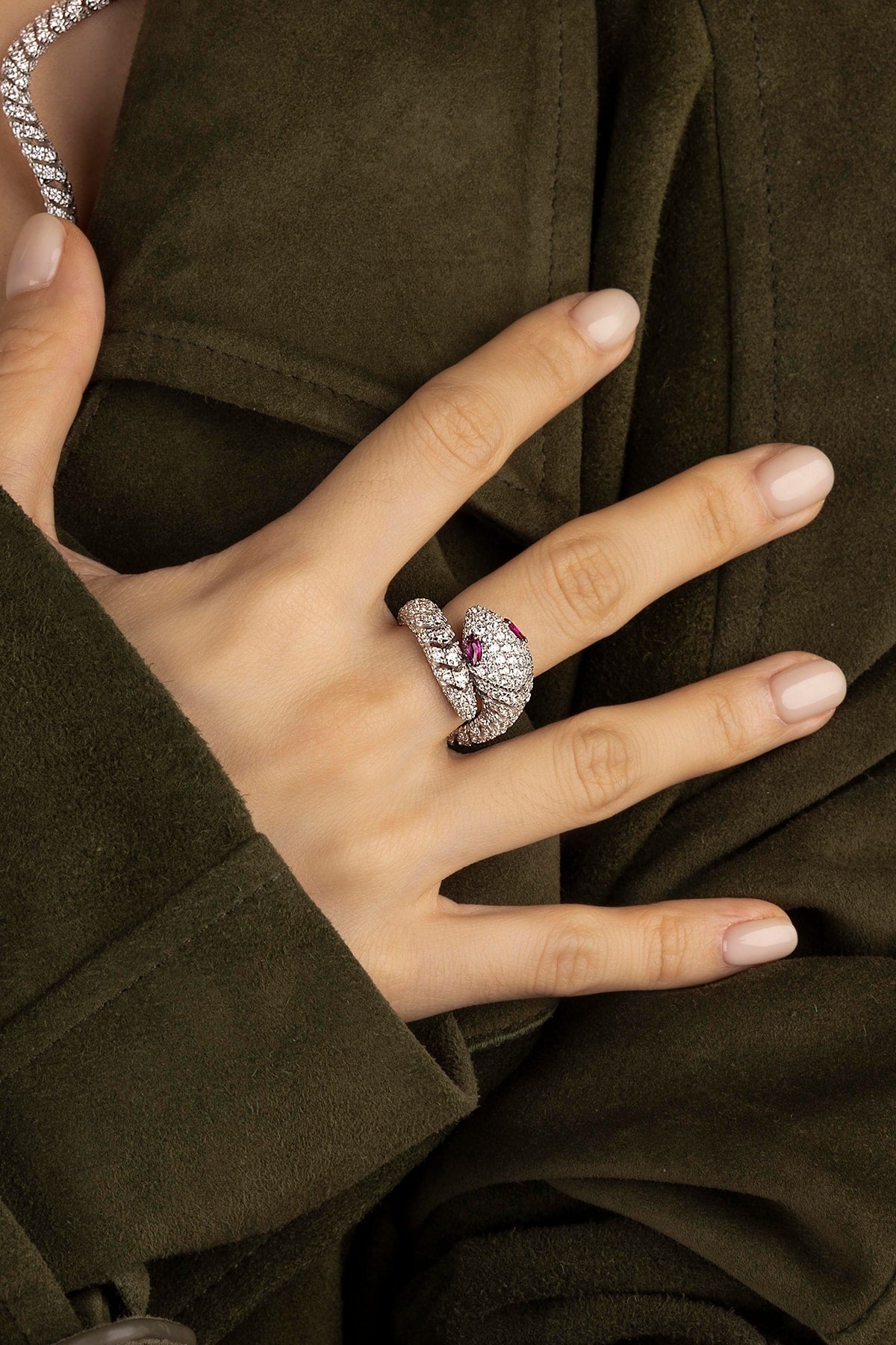 Rings APM Monaco. pavé ring with a coiled design and white stones.