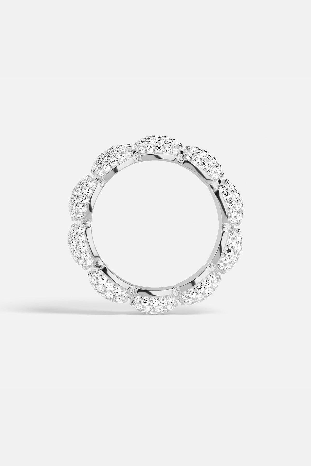 APM MONACO silver ring with embedded white stones on a white background