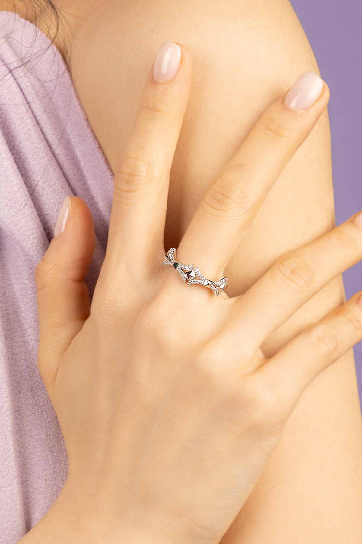 Silver ring on a hand with a soft focus background