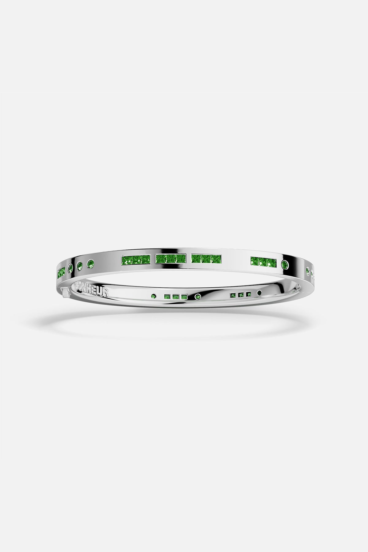 APM MONACO silver bracelet with green stones on a white background