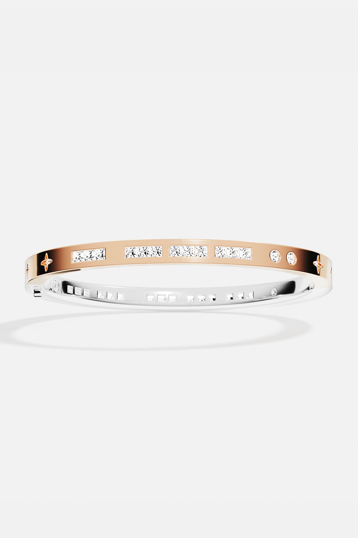 Bracelets APM Monaco two-tone gold and silver bangle with inlaid white stones.