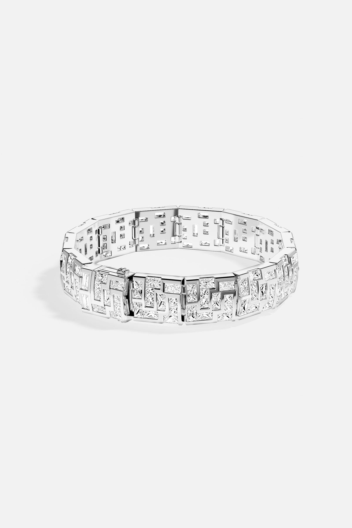 APM MONACO chunky labyrinth bracelet in silver with rectangular stones on a light gray background