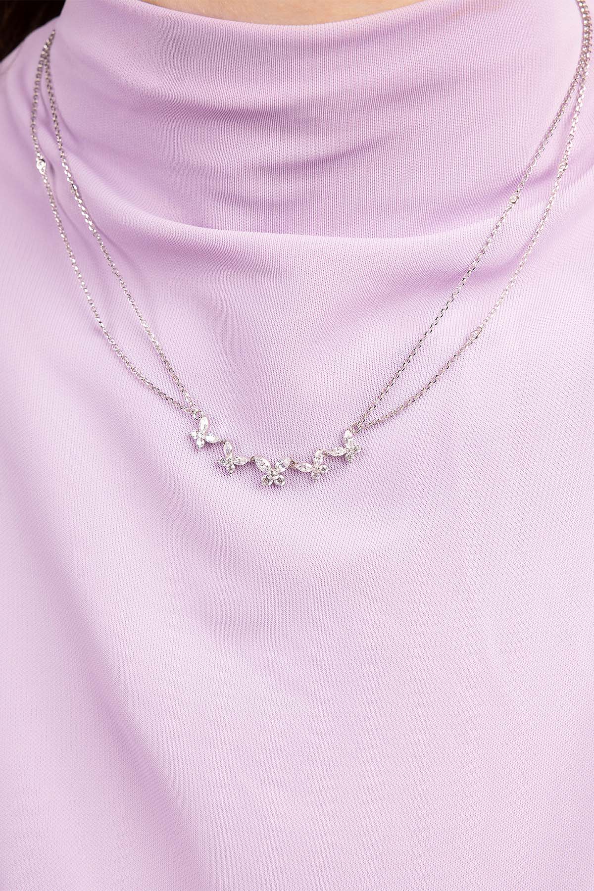 Silver necklace on a light purple turtleneck sweater