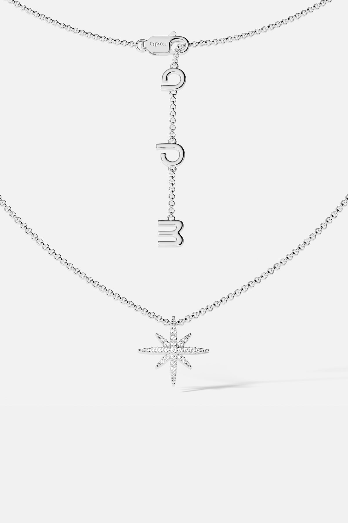 Necklaces APM Monaco, silver star-shaped pendant on a chain with meteorite texture.