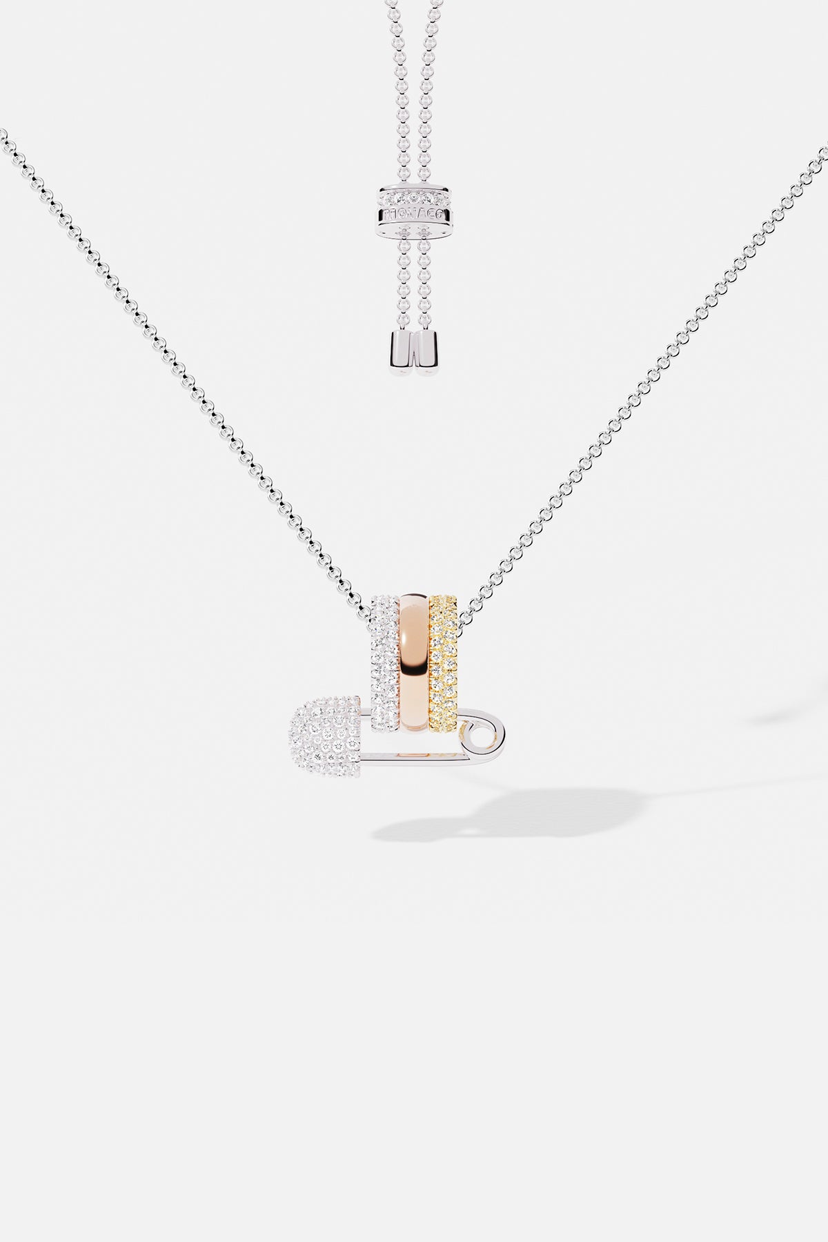 Necklaces APM Monaco multicolor diamond safety-pin pendant on an adjustable white-gold chain with stacked rings.