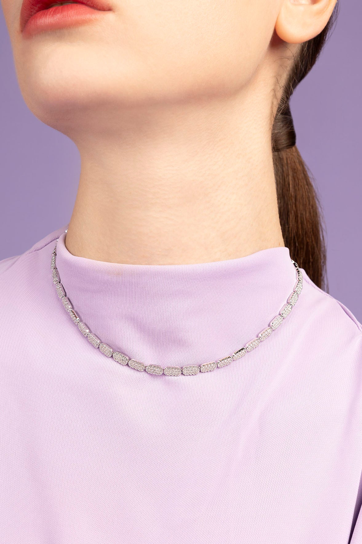 APM MONACO dainty adjustable necklace worn by model on purple background