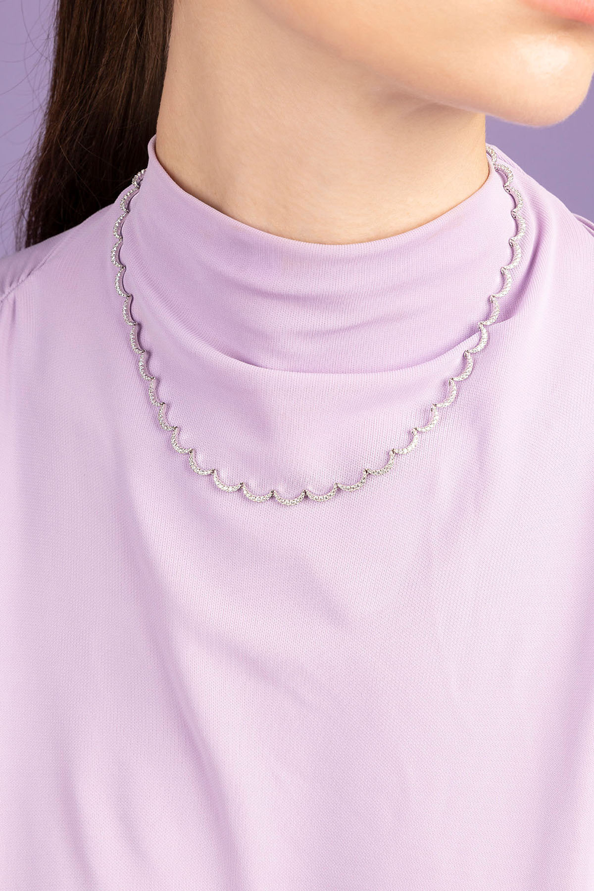 APM Monaco Wavy Silver Adjustable Necklace worn on model with lilac background