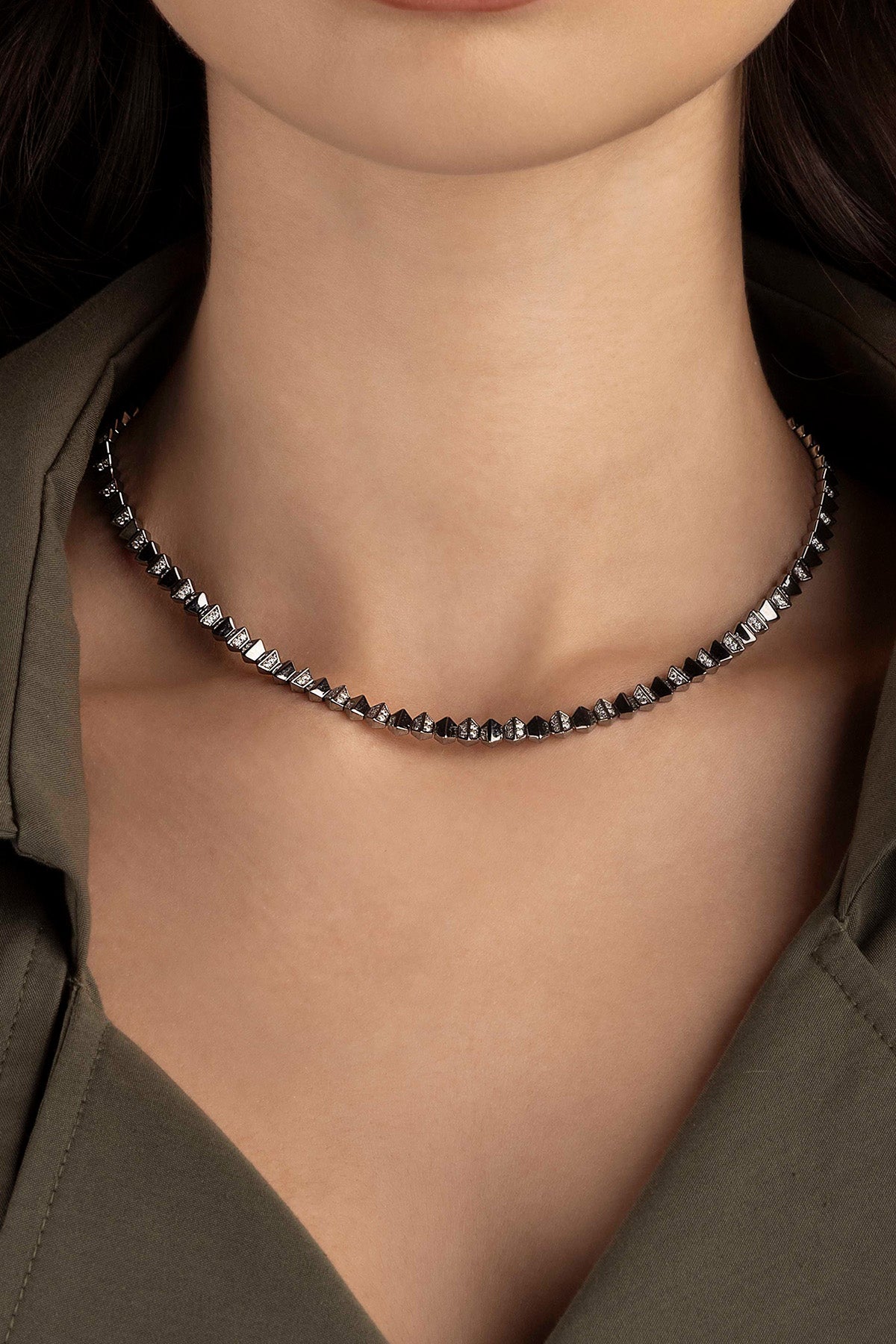 Necklace worn by a model, focusing on the necklace.