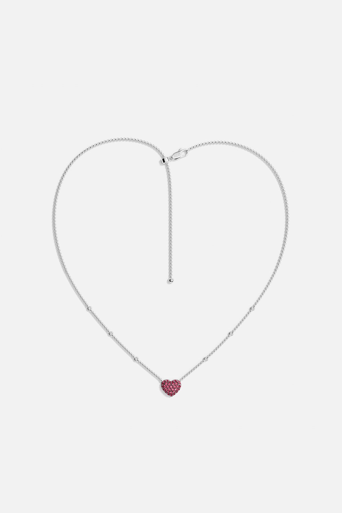 APM MONACO necklace with a heart-shaped fuchsia pendant on a white background