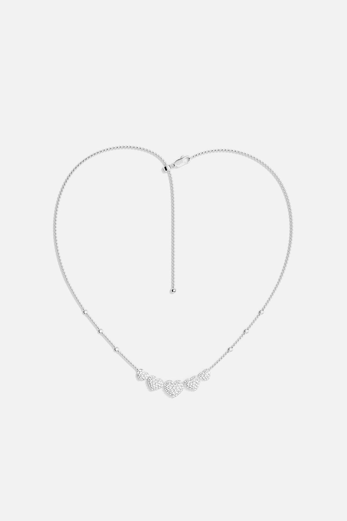 APM MONACO silver necklace with five heart-shaped pendants design on a white background