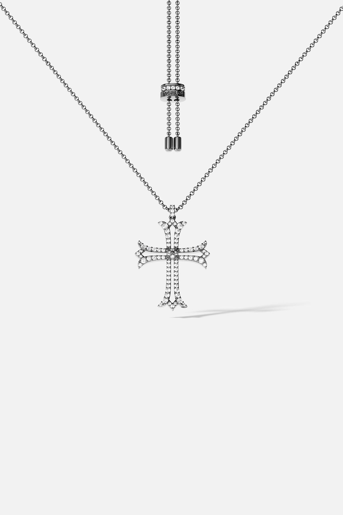 Silver cross pendant necklace on a white background