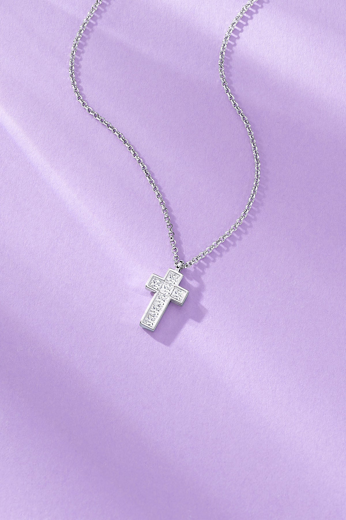Lumière Pavé Cross Adjustable Necklace on a purple background