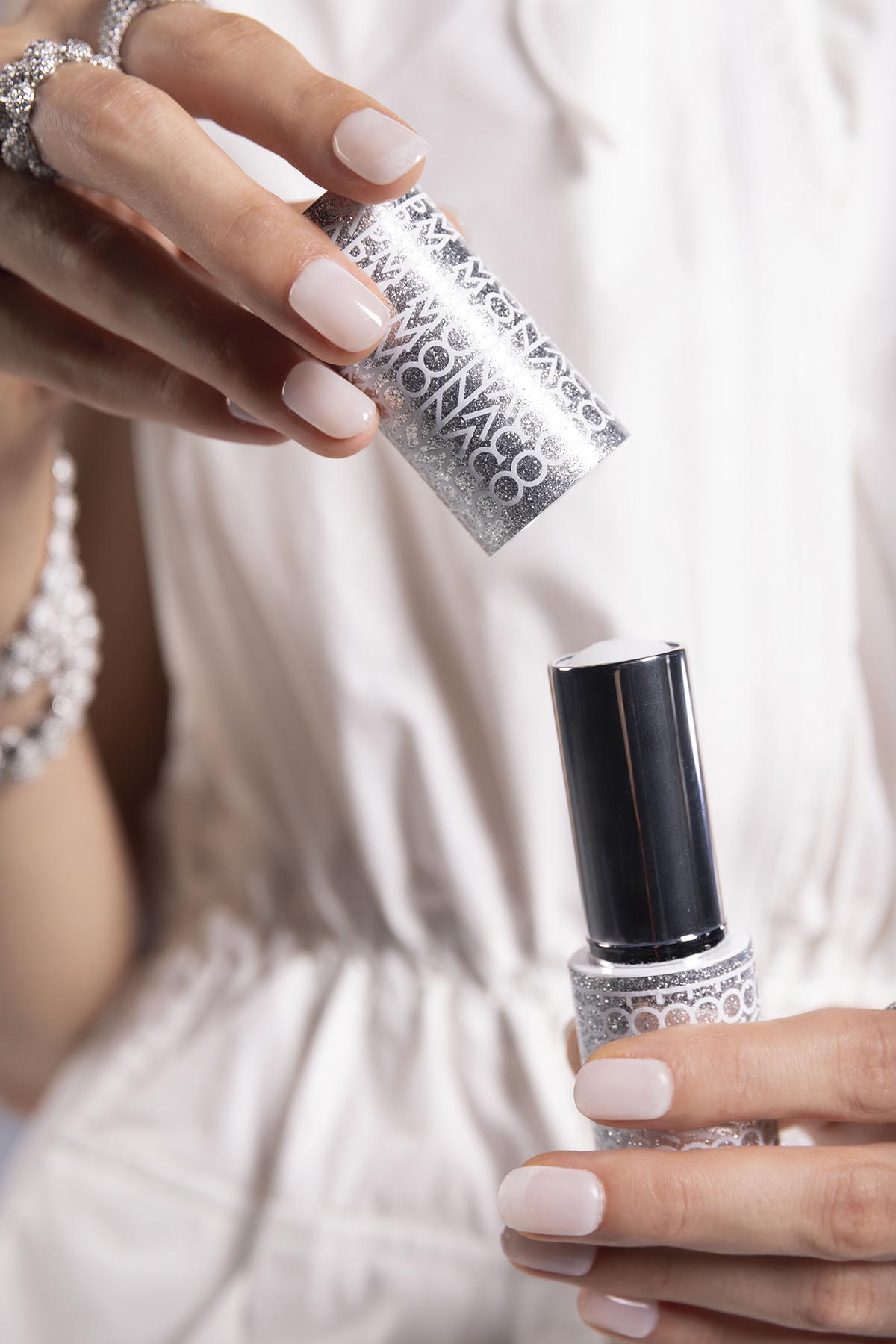 A lip balm with 'APM Monaco' branding held by a person.