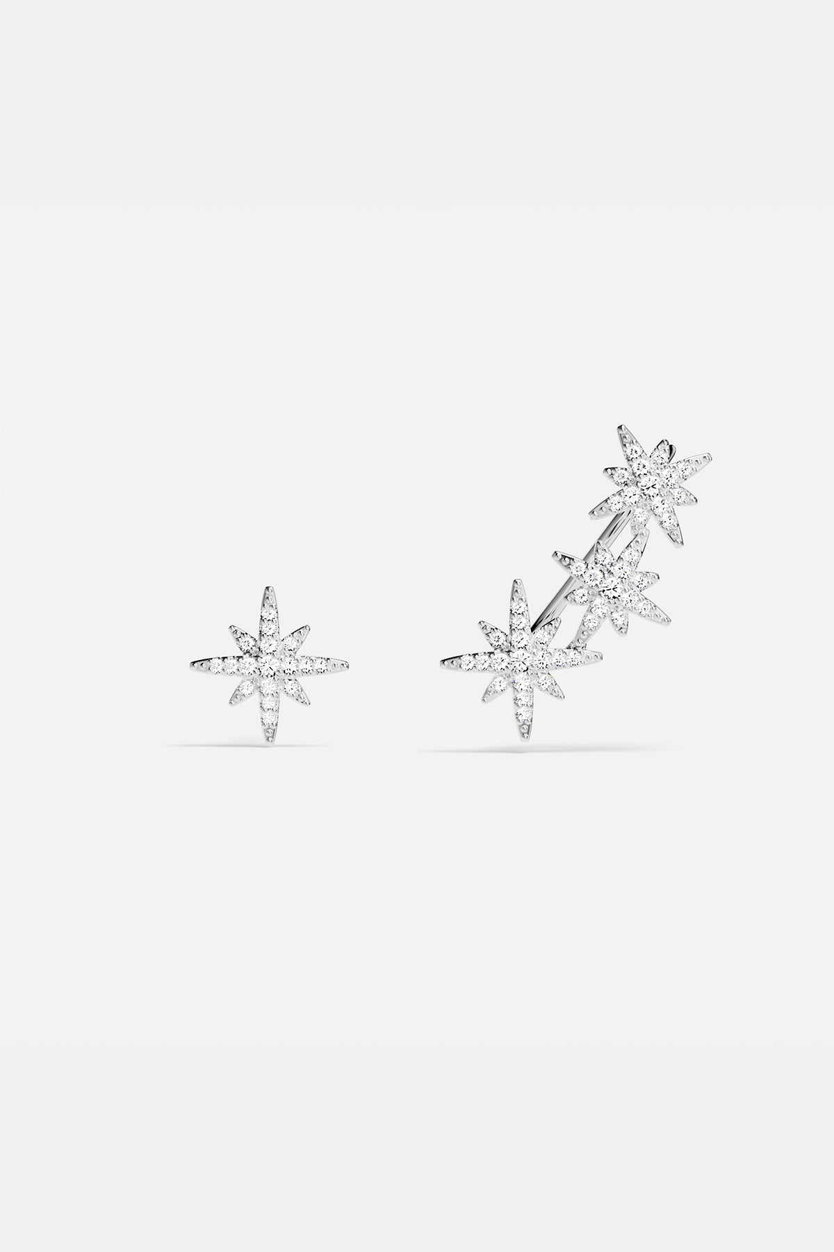 Earrings APM Monaco, silver-tone asymmetric triple meteorite cubic zirconia earrings.