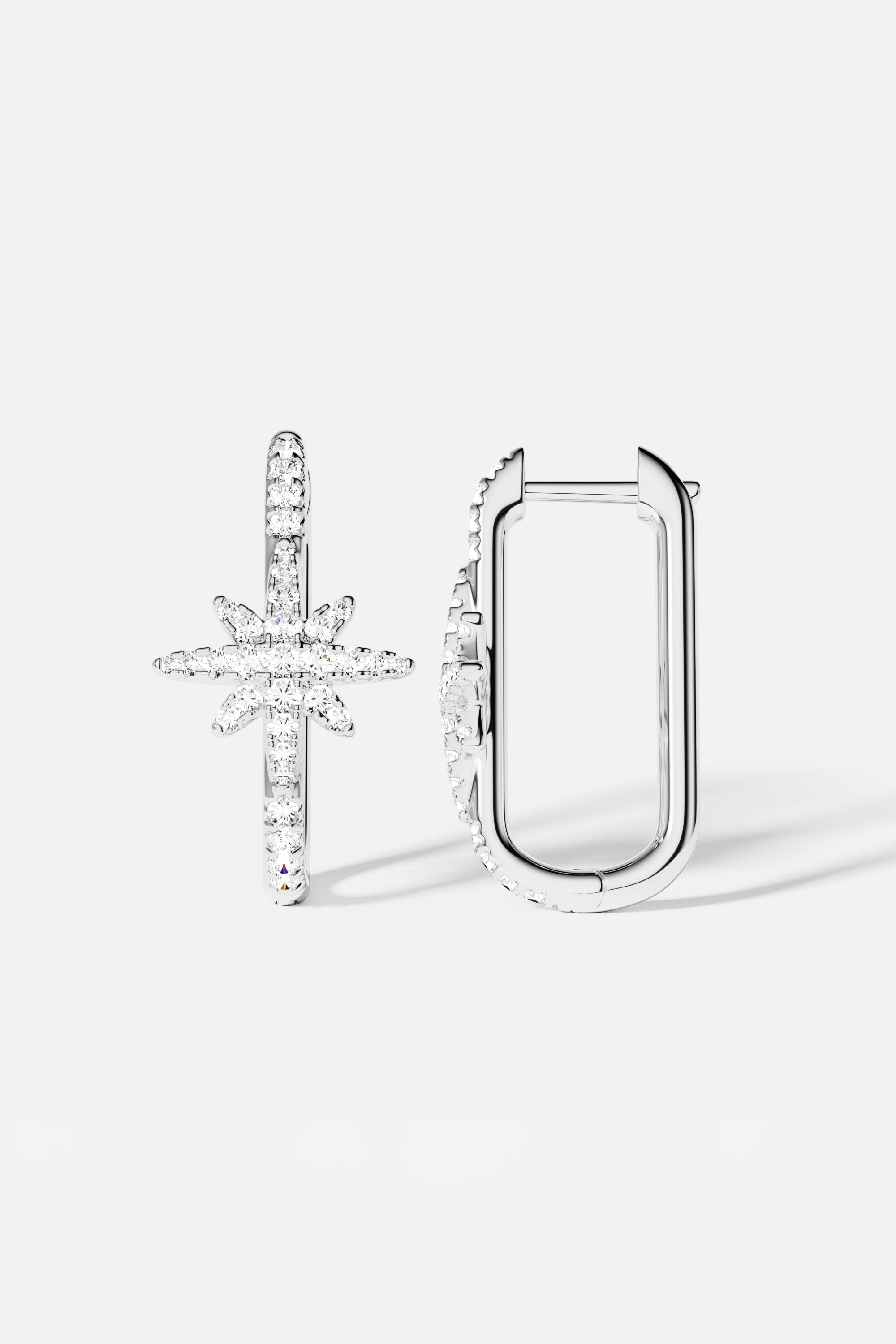 Earrings APM Monaco, silver-tone pair featuring a star-shaped and a U-shaped design.