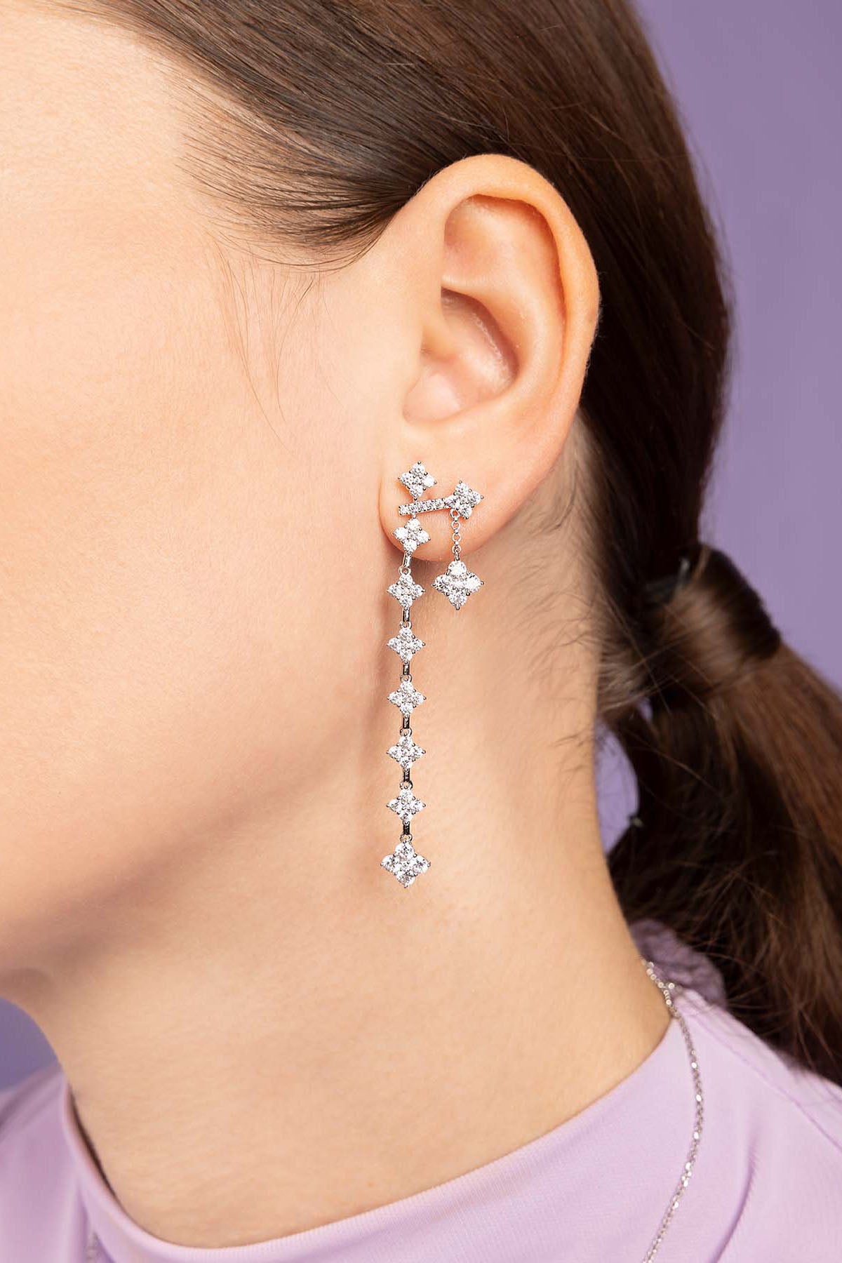 APM Monaco Spark Earring worn on model with lilac background