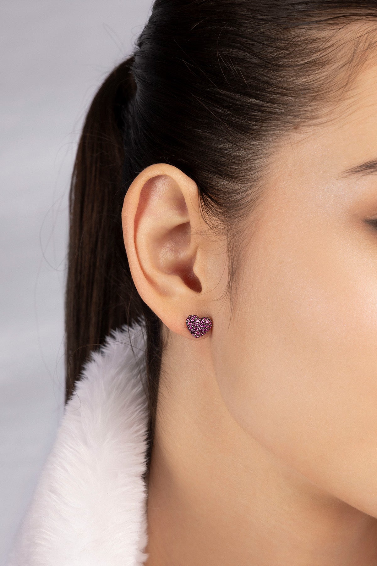 APM MOACO fuchsia heart stud earrings in silver worn on model