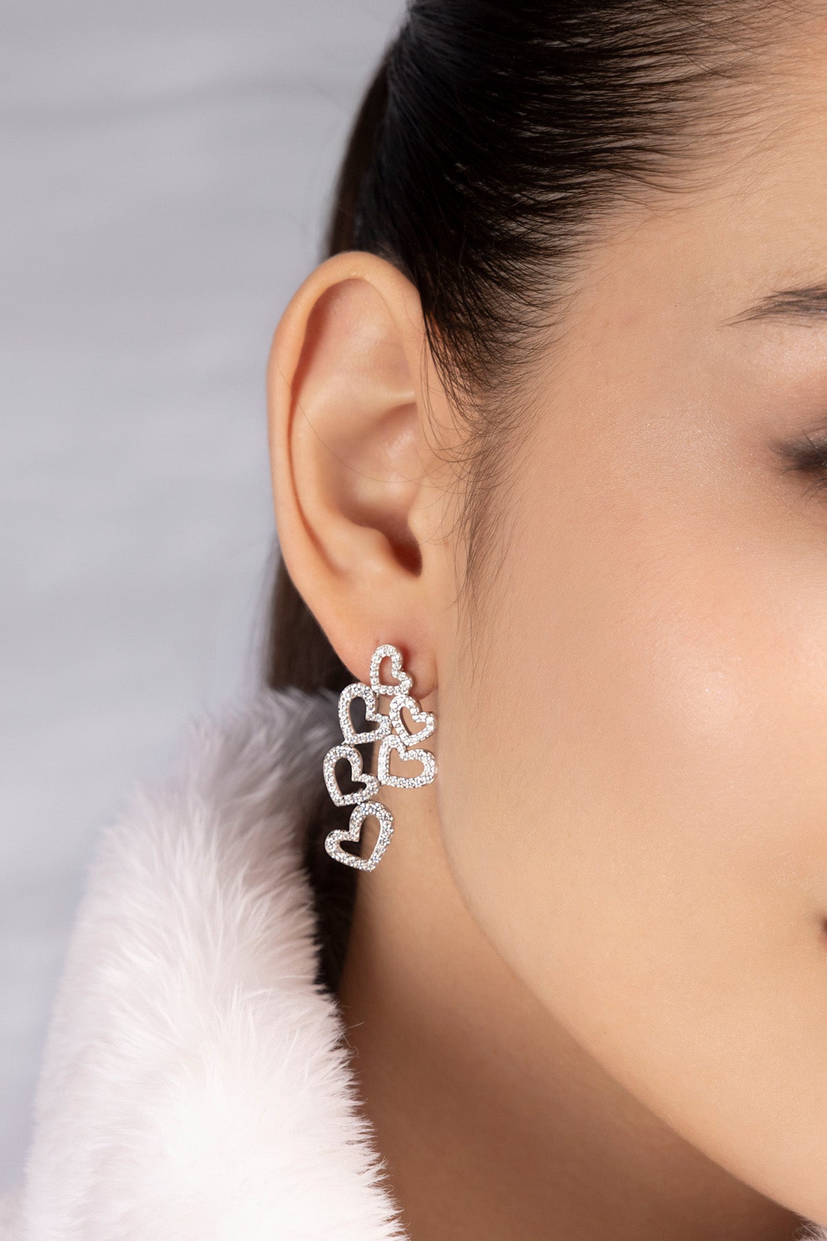 APM MONACO heart-shaped earrings worn on model