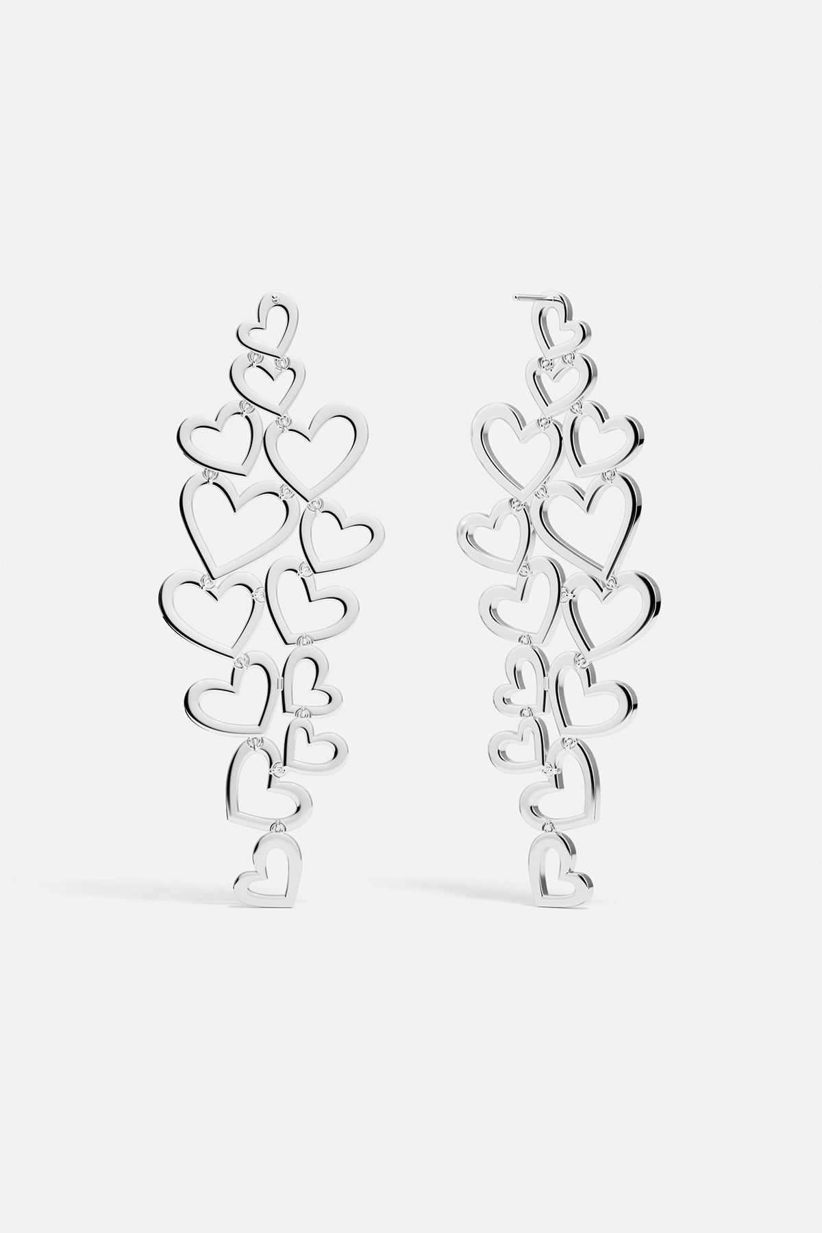 Statement APM MONACO silver heart-shaped earrings on a white background