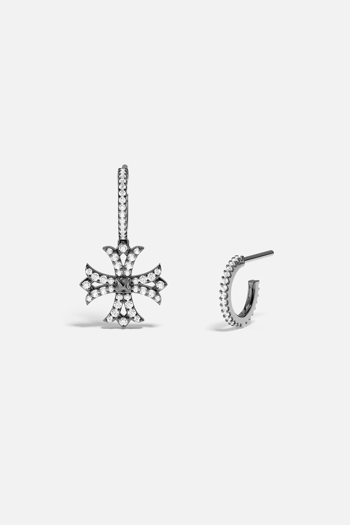 Silver earring with cross design on a white background