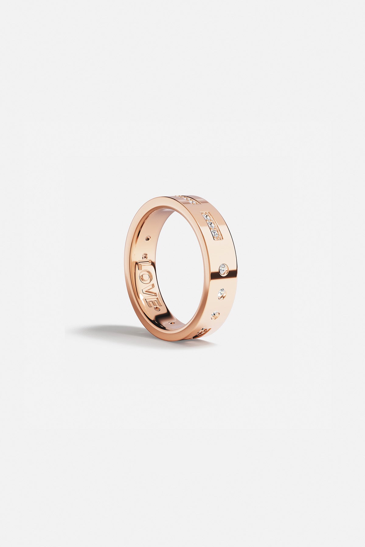 Rings APM Monaco. Rose gold ring featuring a LOVE Morse-code design with small diamonds and star accents.