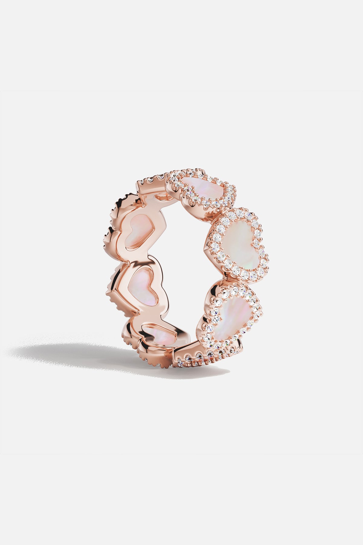 Rings APM Monaco: rose gold pavé ring with pink nacre hearts encircling the band, set with pavé diamonds.