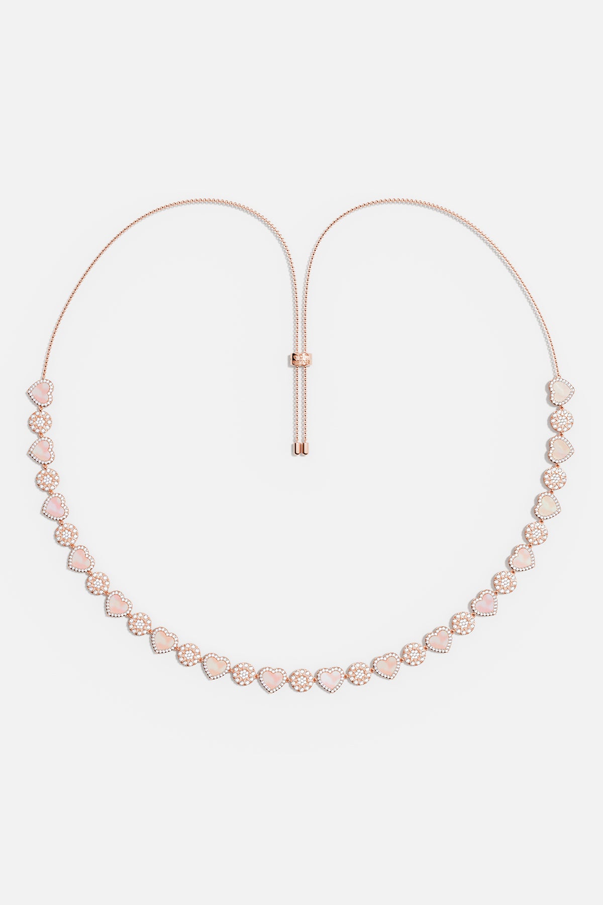 Necklaces APM Monaco. Rose gold tone adjustable necklace with pink nacre heart pendants, separated by small clear stones.
