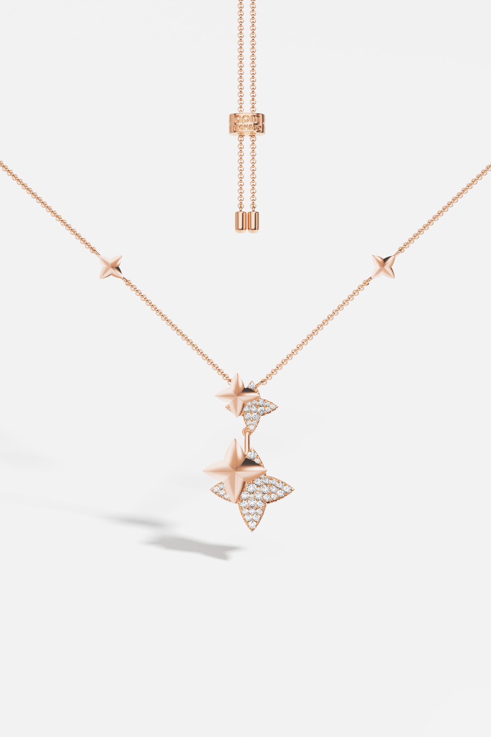 Necklaces APM Monaco, rose gold adjustable necklace with star-shaped pendants, some with inset diamonds.