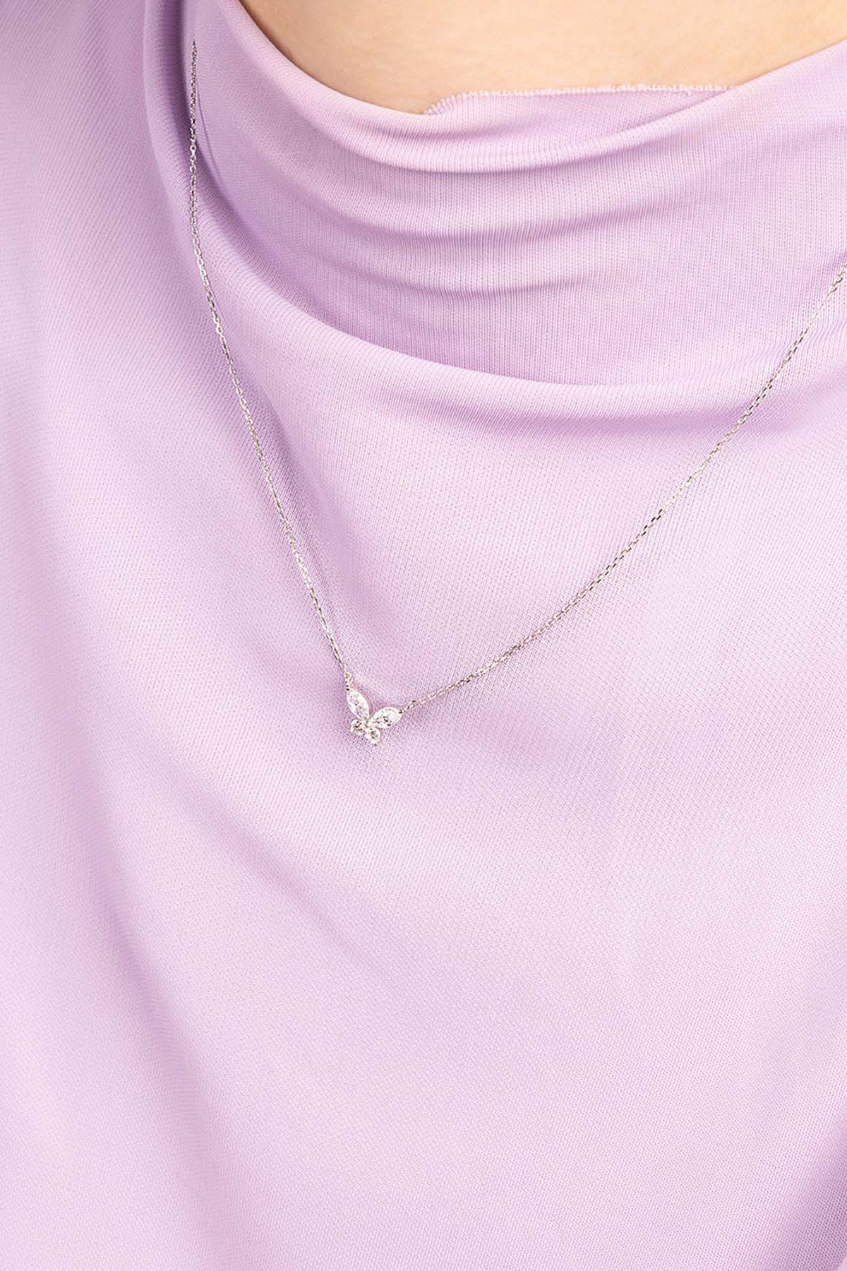 APM MONACO butterfly Necklace on a light purple top