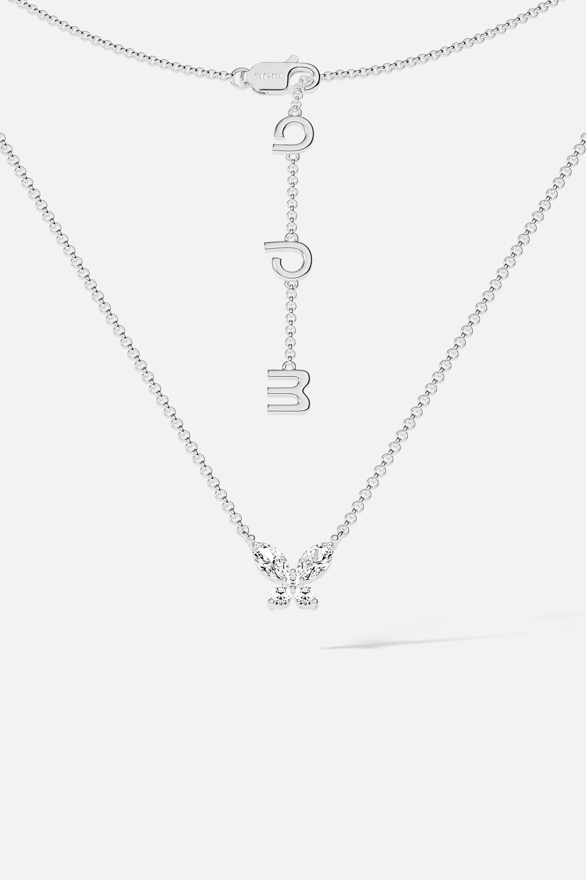 Necklaces APM Monaco. White gold butterfly necklace with white cubic zirconia on a Silver-tone chain; butterfly pendant and APM clasp.