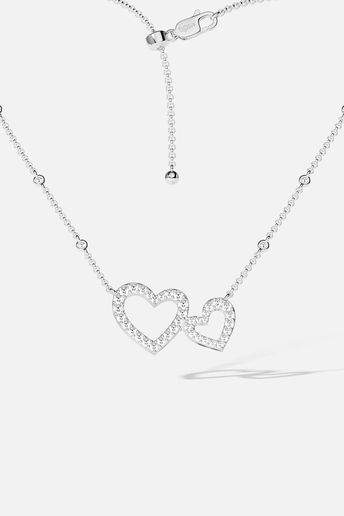 APM MONACO white necklace with heart-shaped pendant on a white background