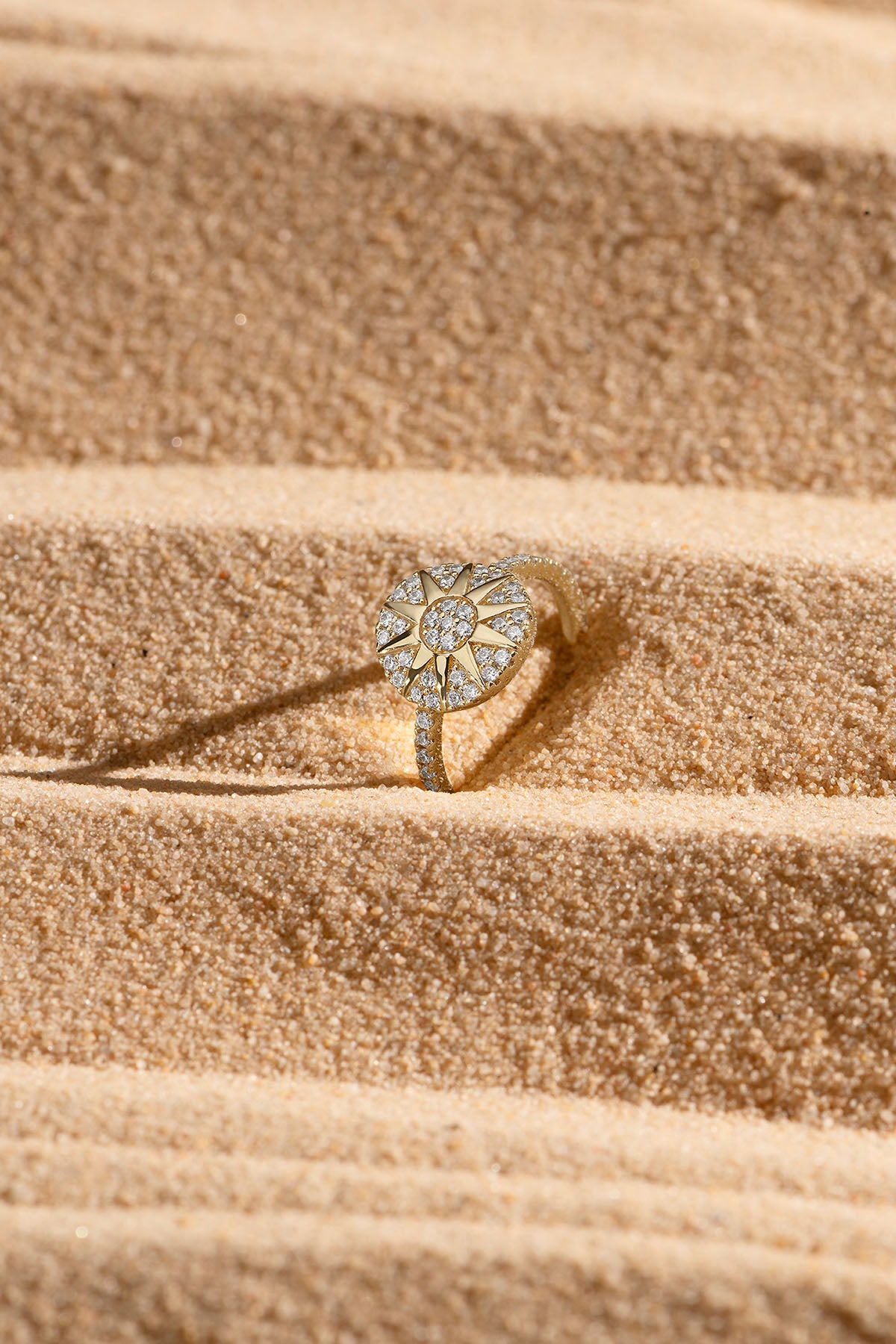 Rings APM Monaco sunburst pavé ring in yellow gold with diamonds.