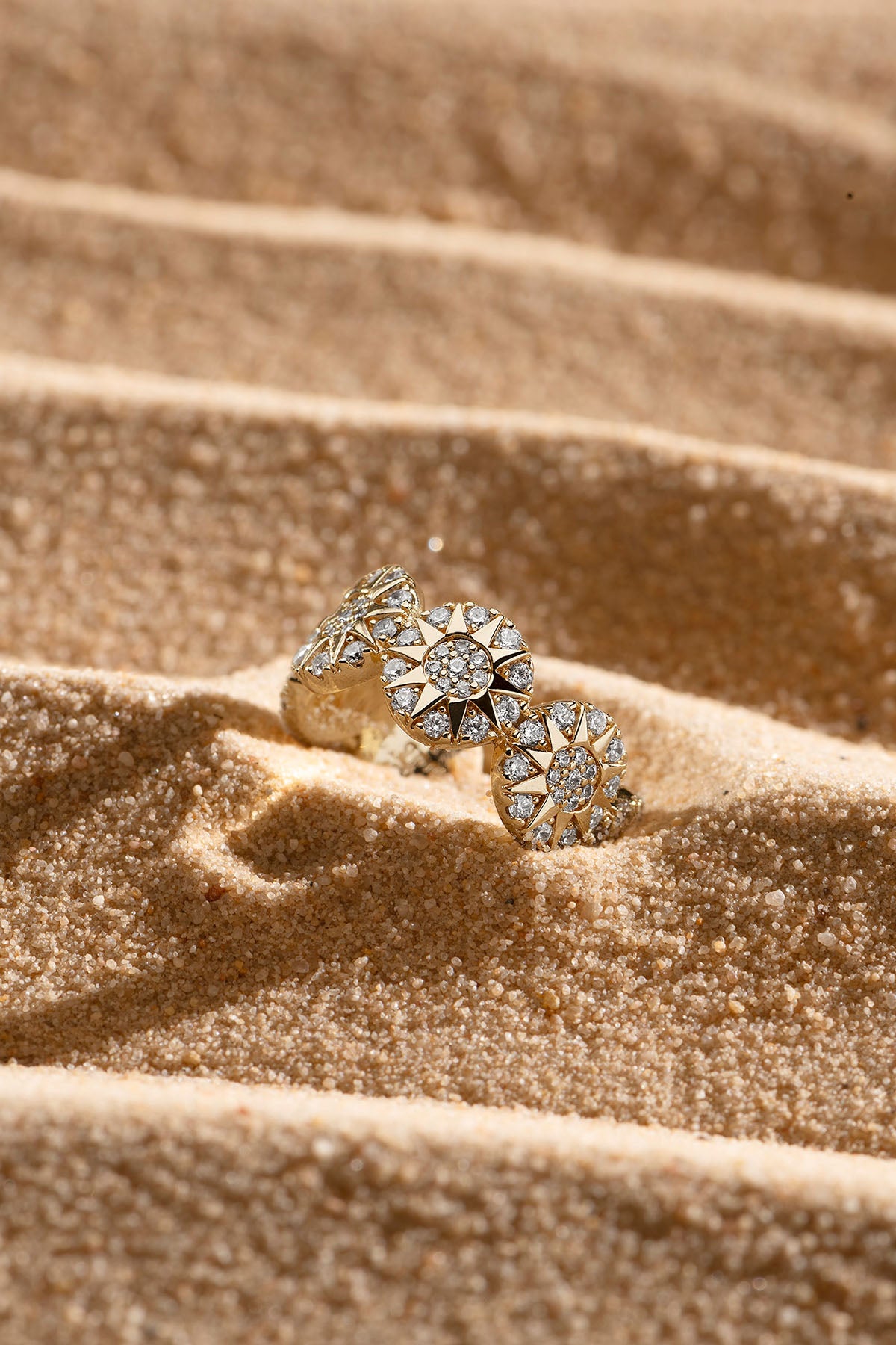 Rings APM Monaco yellow gold triple rosette ring with pavé diamonds.