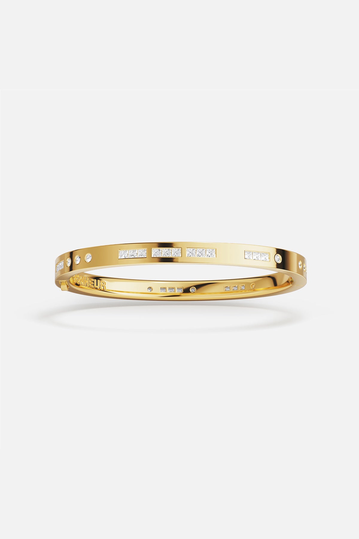 APM MONACO bonheur morse code bangle in yellow gold on white background