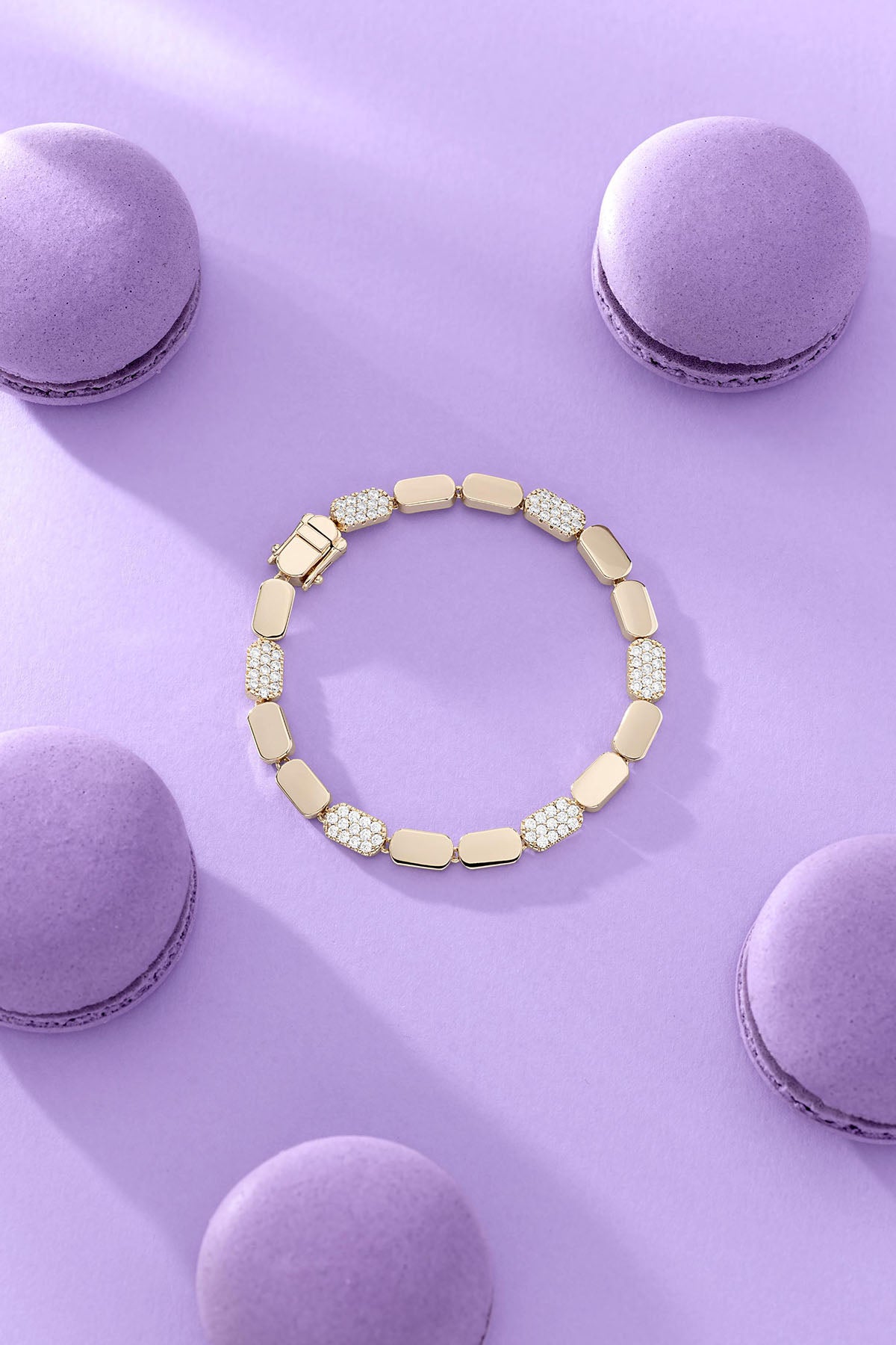 APM Monaco Dainty Gold Bracelet on lilac background with macarons