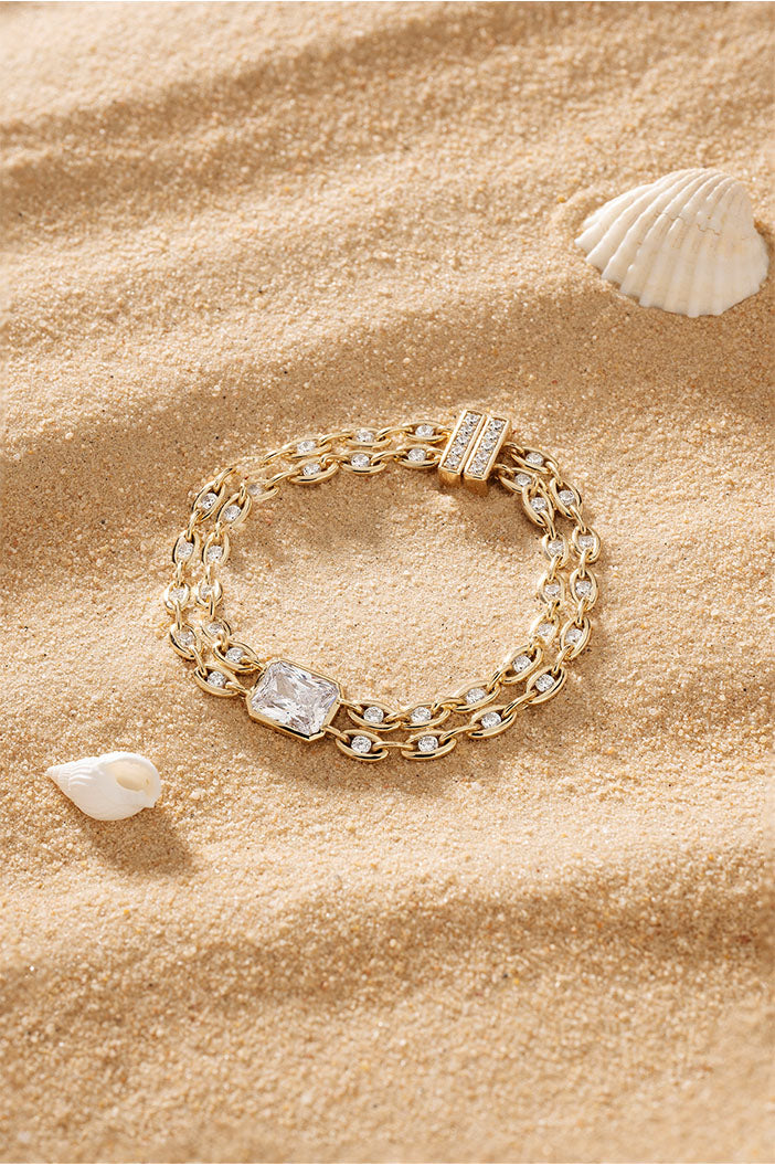 Bracelets APM Monaco yellow gold chain bracelet with a white square crystal accent.
